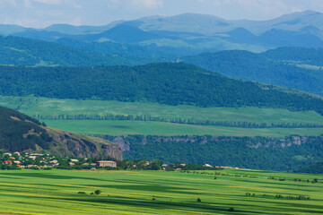 Fototapeta na wymiar Alpine landscape with village and field, Armenia
