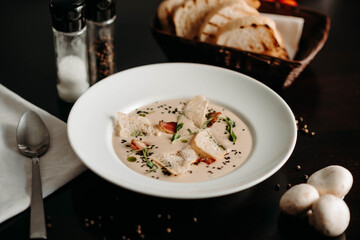 Chopped soup with mushrooms and breadcrumbs in a white plate