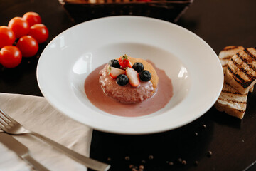 Baked Camembert in Creamy Blueberry Sauce in a white plate