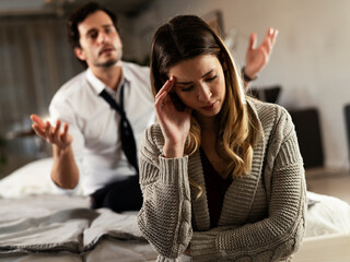 Husband and wife are arguing at home. Angry man is yelling at his wife.