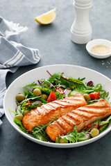 Grilled salmon fillet and fresh vegetable salad. Mediterranean diet.