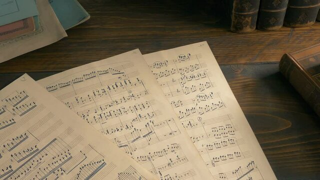 Hand-Written Sheets Of Music On The Table