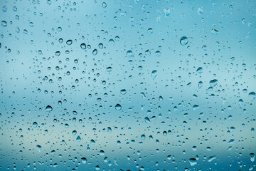 Raindrops on the transparent window pane. Background of raindrops.
