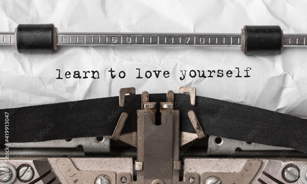 Poster text learn to love yourself typed on retro typewriter