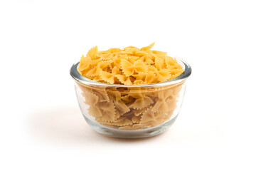 Uncooked pasta, pepper and bottle of oil on white background