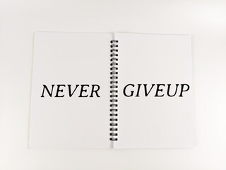A notebook of written "NEVER GIVEUP" isolated with white background. Business concept.
