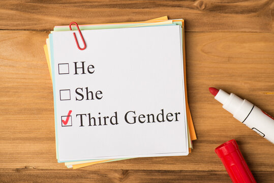 Third gender concept. Photo above of notes paperclips and marker isolated on the wooden background