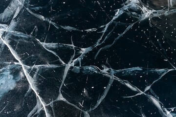 Ice on the Baikal lake. Beautiful cracked ice in winter close-up.