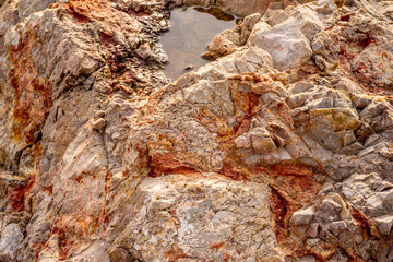 Stones texture nature photo with lake. Rock background. Mountain close-up. Mountain texture.