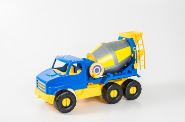 Fototapeta na wymiar Plastic car. Toy model isolated on a white background. Yellow-blue concrete truck.