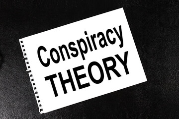 Conspiracy Theory. text on white paper on black background