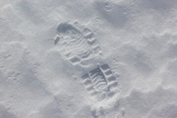 Human boots footprints in snow. Boot print on the snow.