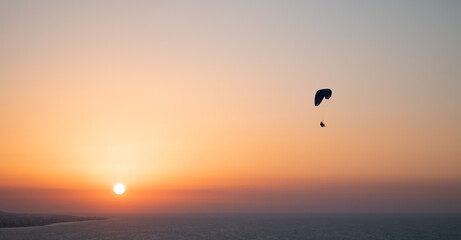 Parachuting - Paragliding in sunset