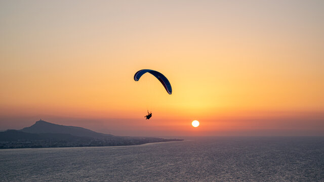 Parachuting - Paragliding in sunset