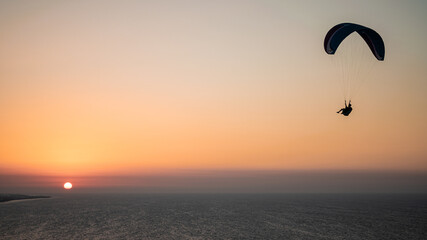 Parachuting - Paragliding in sunset