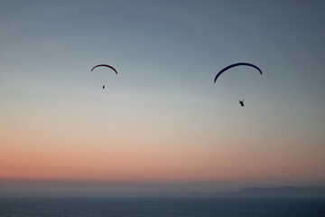 Parachuting - Paragliding in sunset