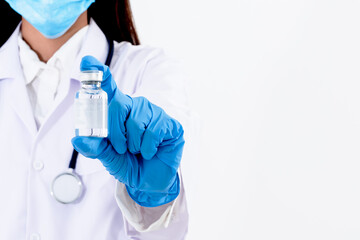 Blurred soft images of doctor woman Holding a vaccine bottle to treat the coronavirus or COVID-19 infection, On white background to health care and virus infection concept.