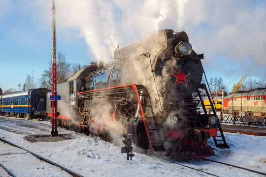 SORTAVALA, RUSSIA - MARCH 10, 2021: Tourist retro train on steam locomotive departs from Sortavala station to Ruskeala Mountain Park