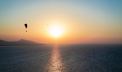Parachuting - Paragliding in sunset