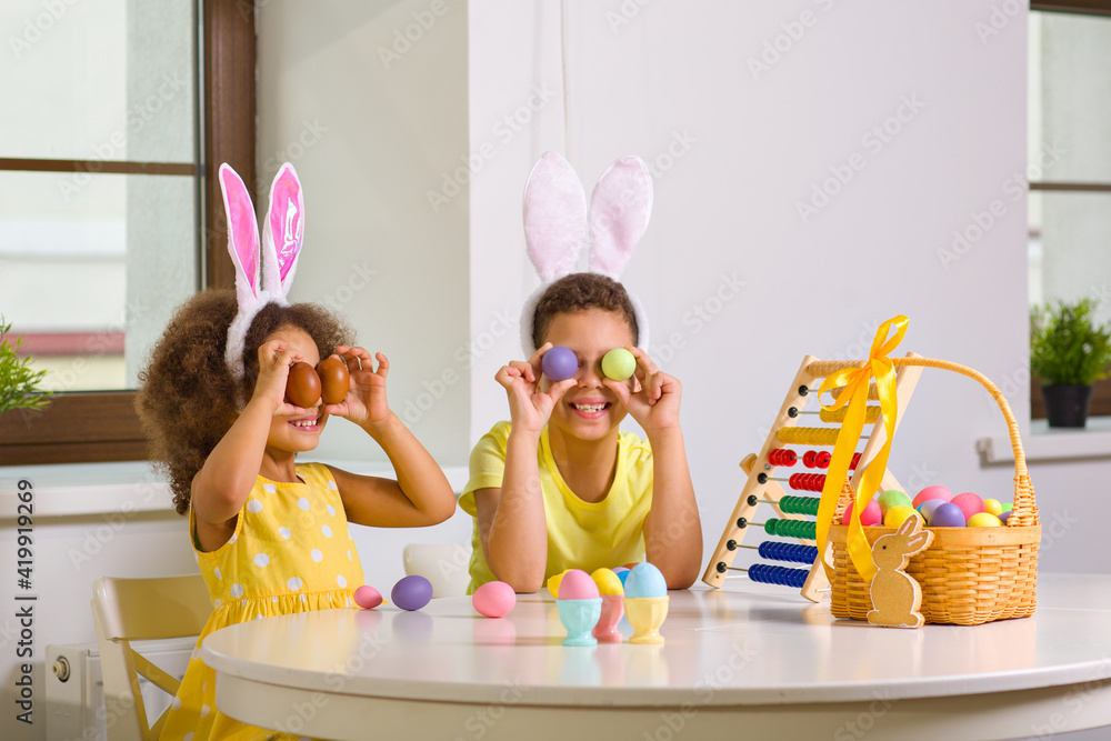 Wall mural a black african-american boy and his sister counts on their abacus the eggs collected during the eas