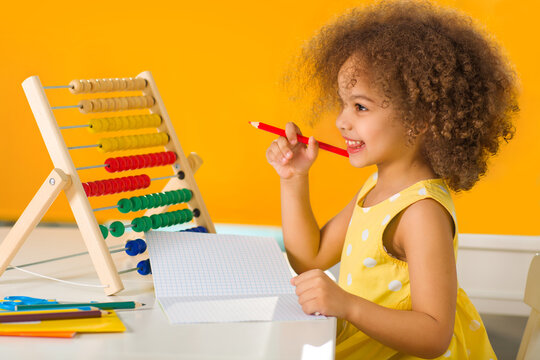 A Black African-American girl is ready for a math and arithmetic lesson with abacus