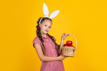 happy teen girl in bunny ears hold basket with apples, easter harvest