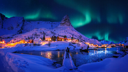 Impressive winter scenery. Northern lights appear over Reinefjord, Lofoten islands. Norway. Lofoten...