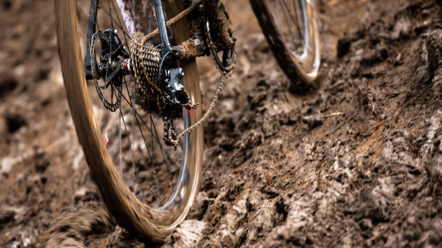 Cyclocross bicycle rear wheel sliding through muddy track