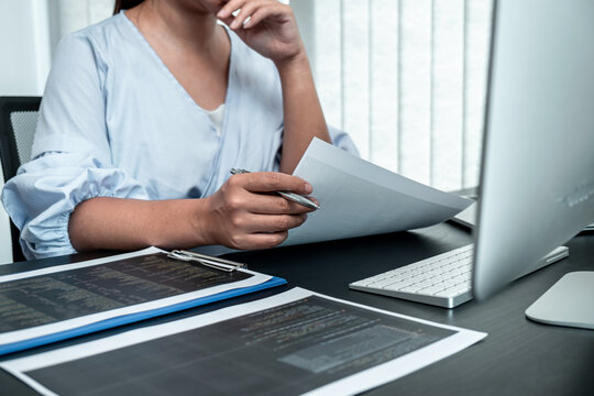 Female Programmer working in software javascript computer in IT office, Writing codes and data code website and coding database technologies to find solution to problem