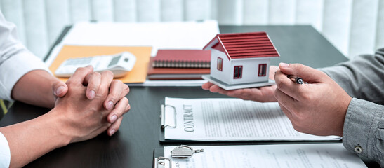 Estate agent are presenting home loan to client and discussing to decision signing agreement...