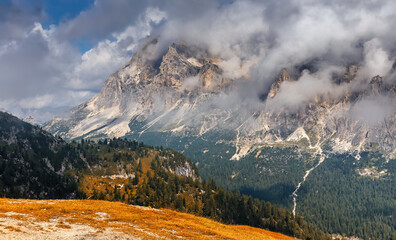 Amazing nature lanscape. Unsurpassed  scenery in Dolomite. Cloudy mountain Tofana di rozes of the Dolomites near Cortina D'ampezzo in Italy. Concept of ideal resting place. Popular travel destination.