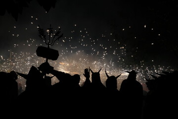 Traditional festival of Catalonia, people dance under the fire and the sound of firecrackers