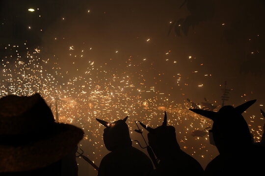 Traditional festival of Catalonia, people dance under the fire and the sound of firecrackers