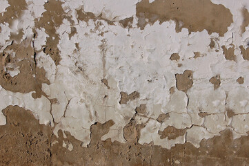 Old scratched plaster wall with ocher base