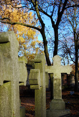 three tombstone crosses on a cemetery in berlin