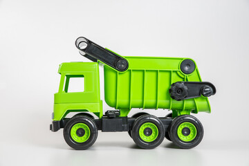 Plastic car. Toy model isolated on a white background. Green truck.