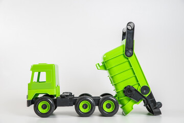 Plastic car. Toy model isolated on a white background. Green truck.