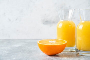 Glass pitchers of juice with slice of orange fruit