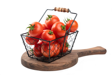 A metallic black basket bowl full of fresh red juicy tomatoes