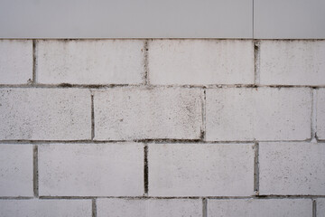 Texture of a concrete block wall painted white. Concrete wall as background or texture. Part of a block wall, for background or texture.