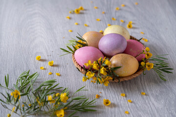 Easter eggs decorated with yellow flowers on a wooden table