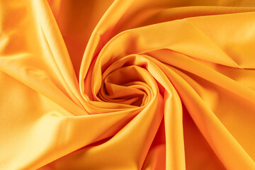 twisted into a spiral fabric of bright orange color for tailoring, background