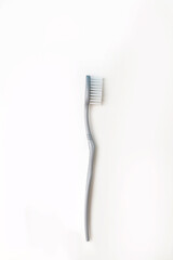 one gray toothbrush on a white isolated background. the concept of oral care and dental care