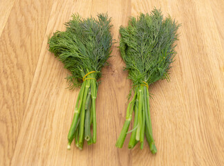 Dill on a wooden background. the benefits of dill