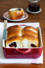 Austrian buns with cherry filling in a baking dish. Rustic style.