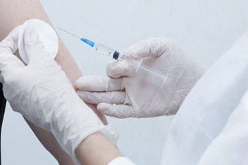 a nurse makes a vaccine for a patient