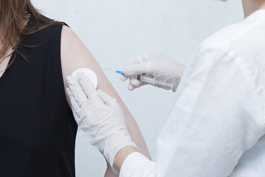 a nurse makes a vaccine for a patient