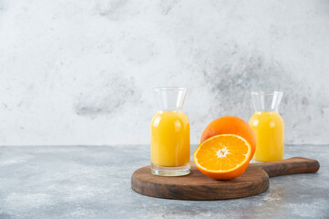 Glass pitchers of juice with slice of orange fruit