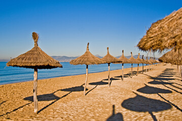 Straw Umbrellas On The Beach