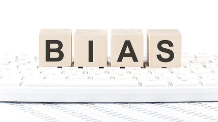BIAS -word wooden block on keyboard background witn chart